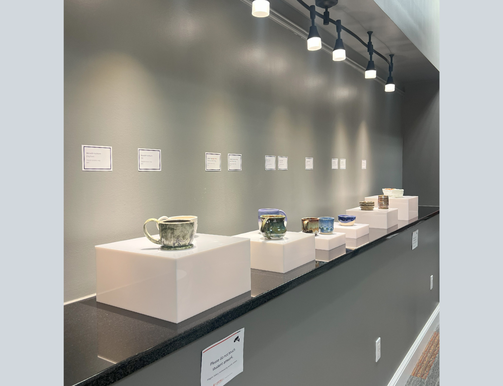 Side view of ceramics exhibit by students Meredith Ashburn, Kaitlyn Buckner, E-monnie Cheeks, Gunnar Hardt, Jamari Cannady Pratt, and Samantha Terrio.